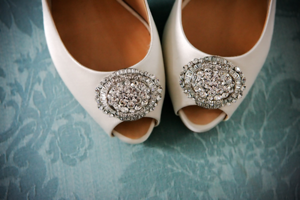 photo of a pair of white peep toe wedding shoes with rhinestone decor - photo by Italian wedding photographer JoAnne Dunn